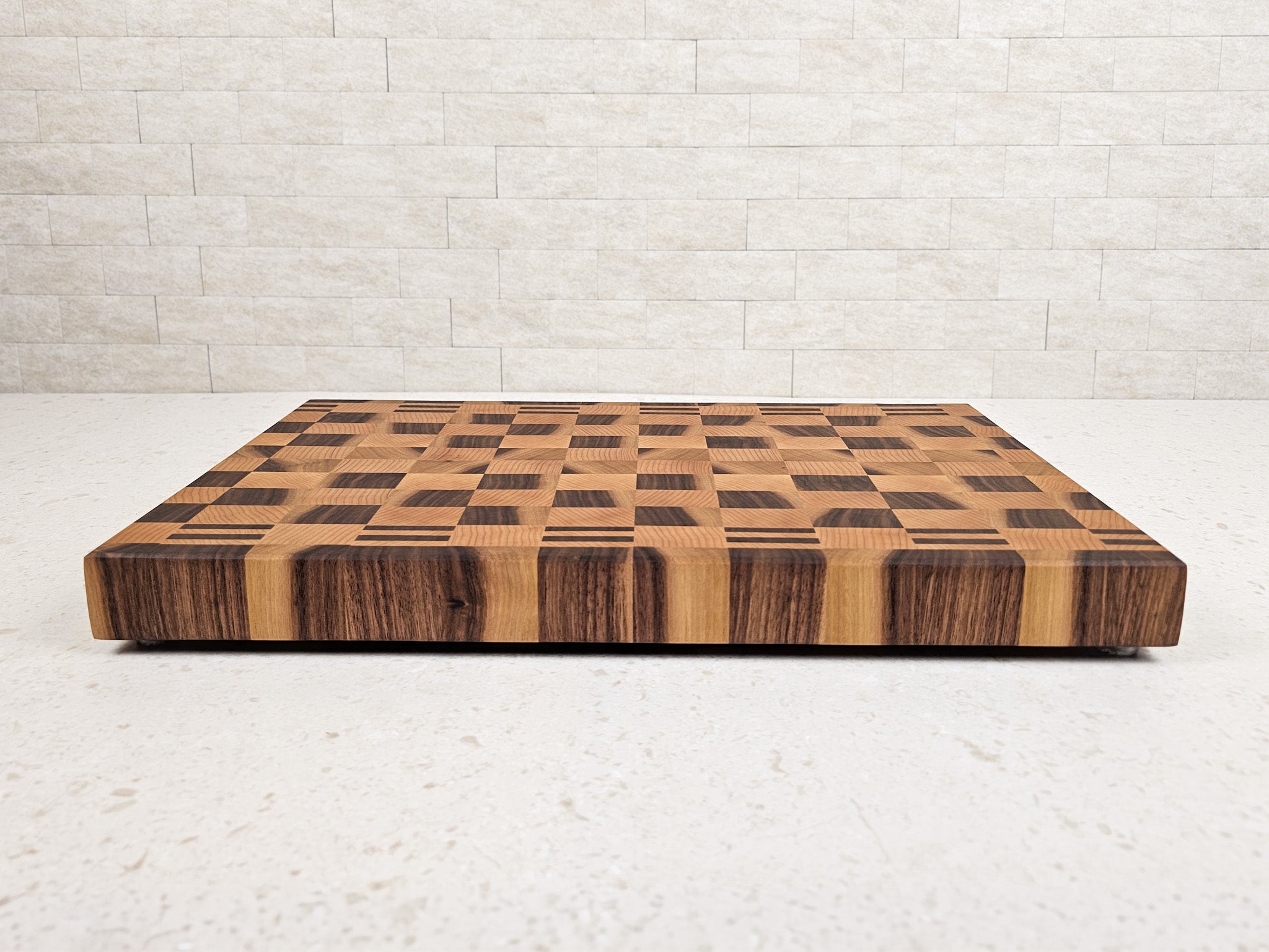 Wooden cutting board with checkered pattern on a light gray background
