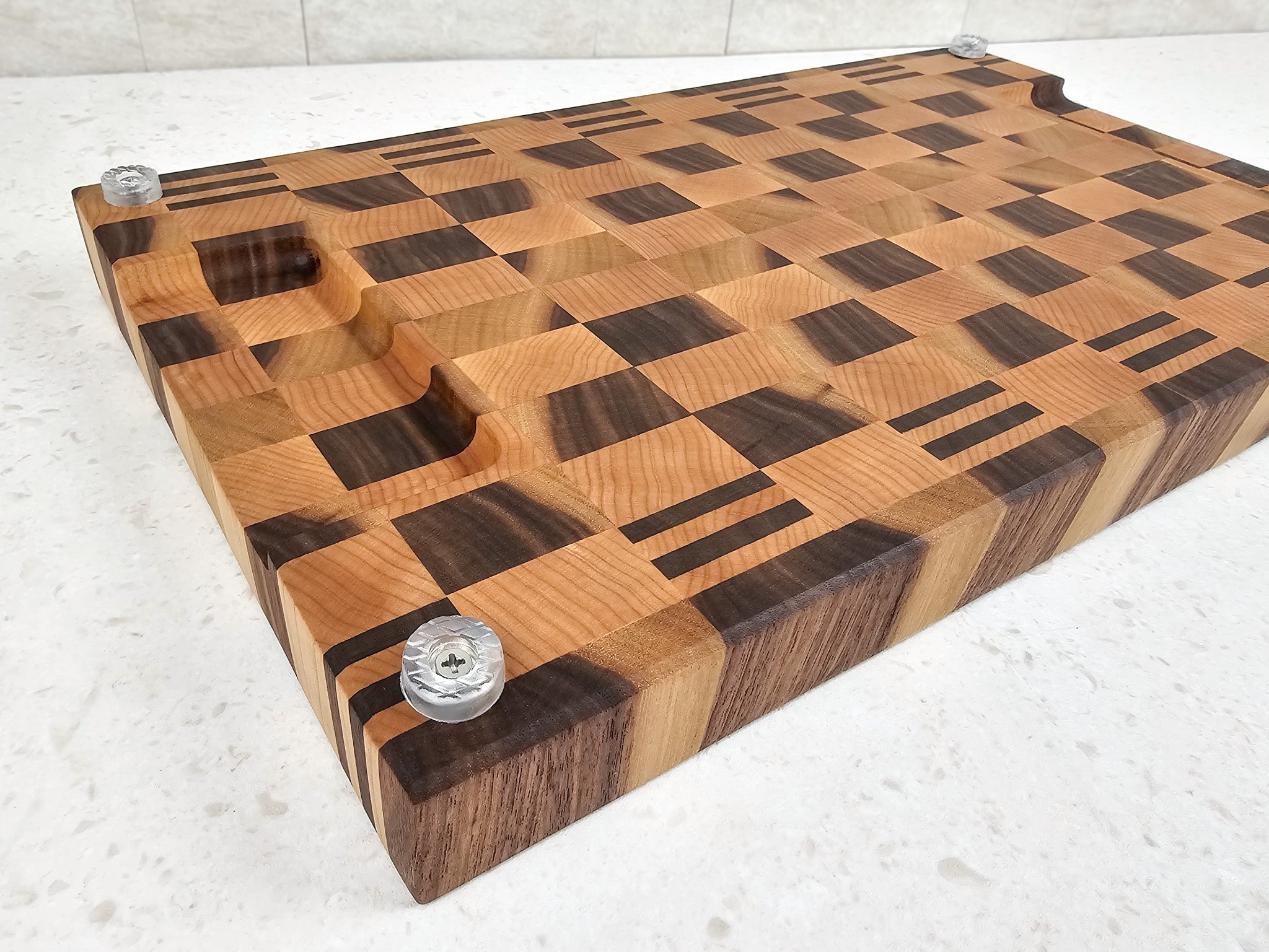 Wooden cutting board placed upside-down to show silicone feet